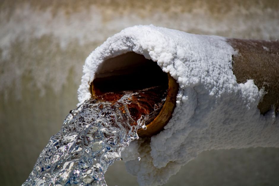 Borewell cleaning service flushing water from a well pipe